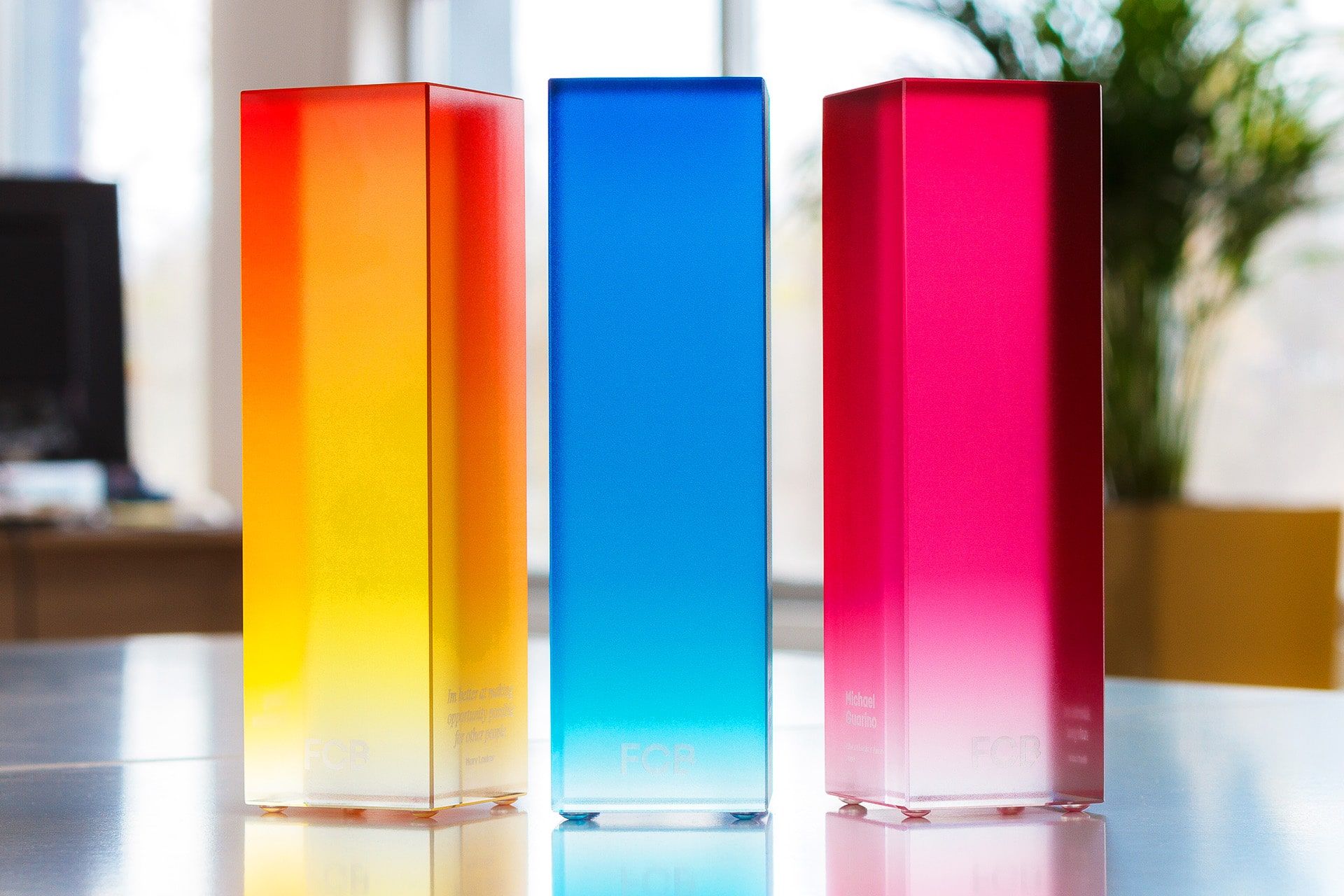 Three rectangular Glass awards featuring vibrant gradient UV prints in orange, blue, and pink, suitable for business and finance recognition.