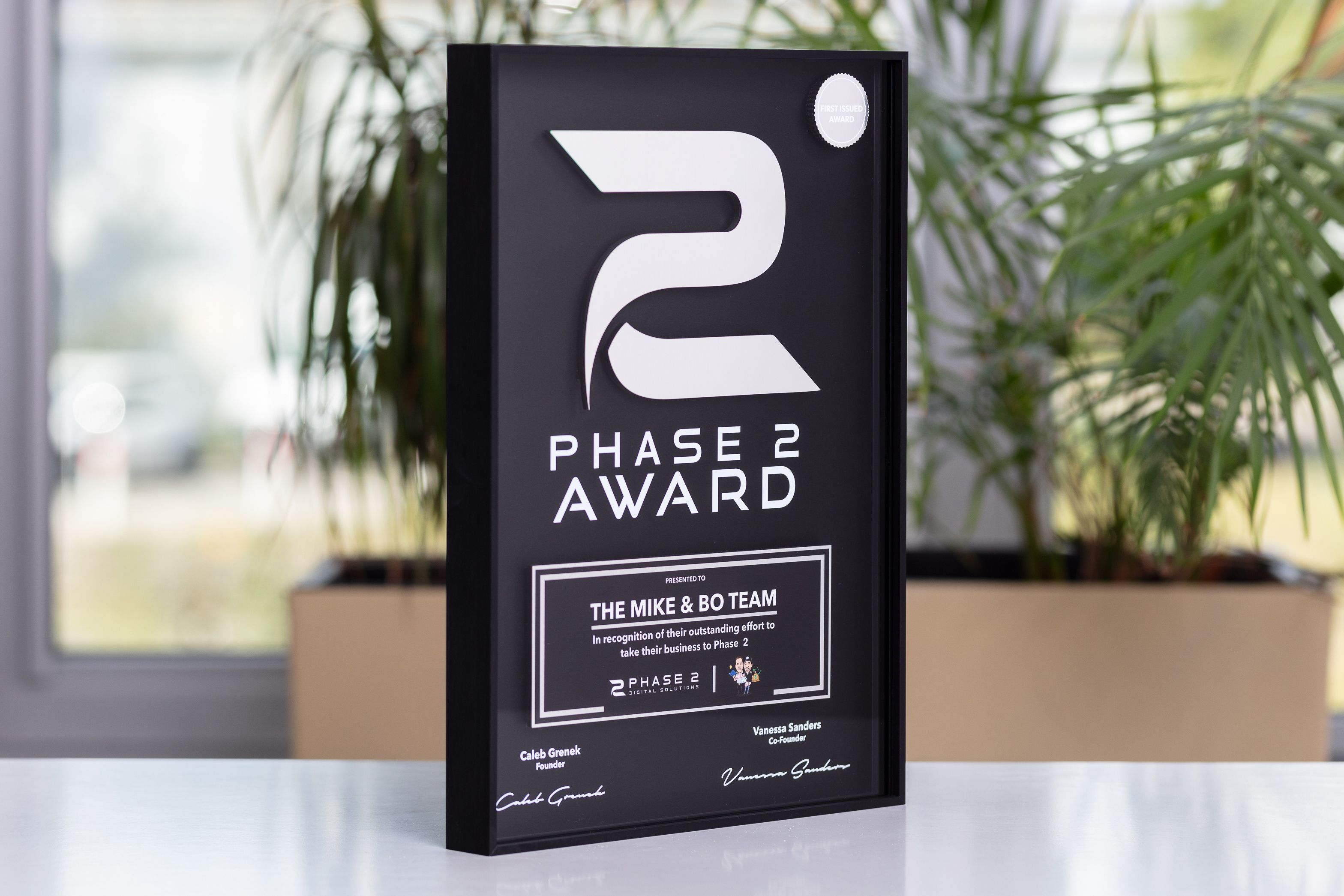 Sleek black Metal and Frames award for the IT industry, featuring a large white '2' logo and custom text.